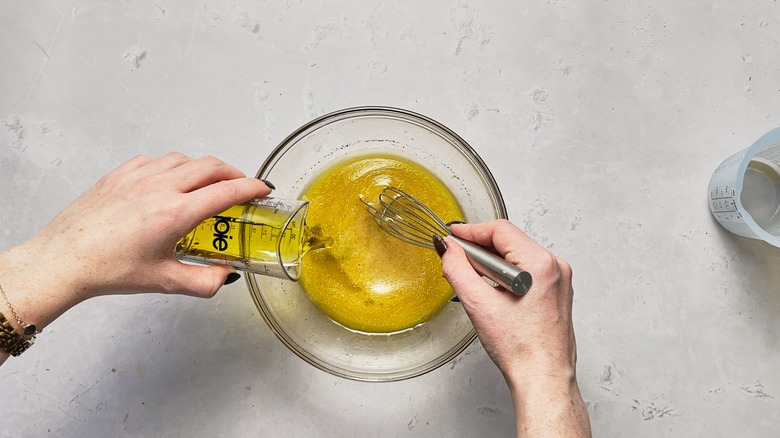 whisking oil into dressing