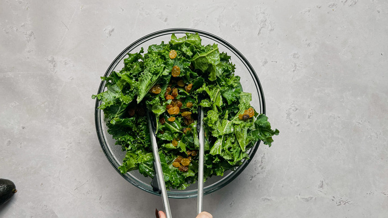 tossing raisins with kale