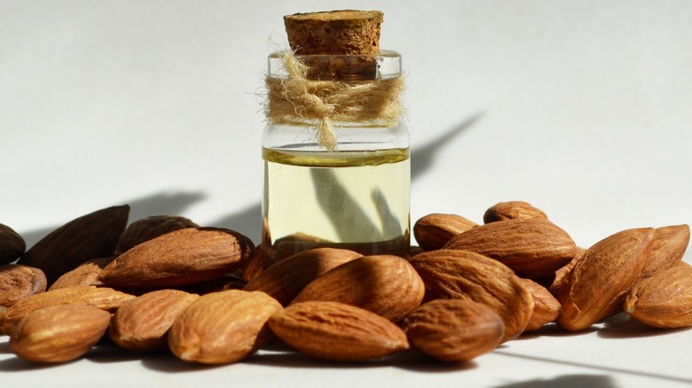 Almond extract in bottle plus almonds