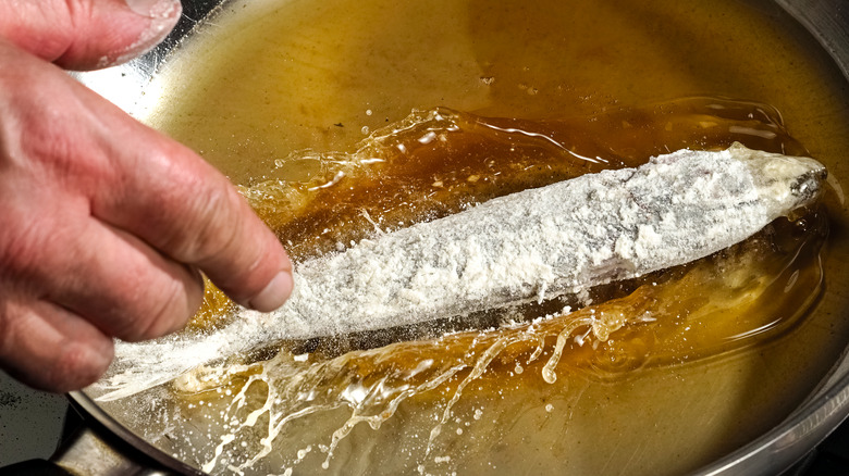 Frying fish coated in flour