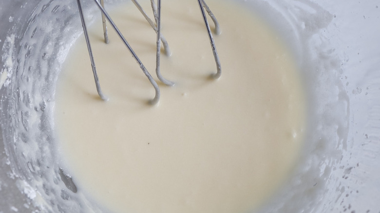 white frosting in clear bowl