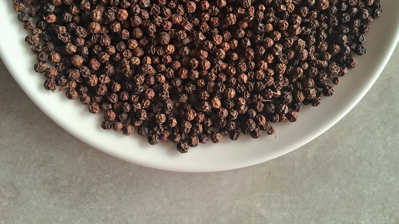 A bowl of black peppercorn