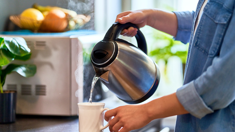 Electric kettle pouring water