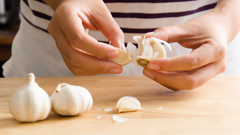 peeling garlic with hands