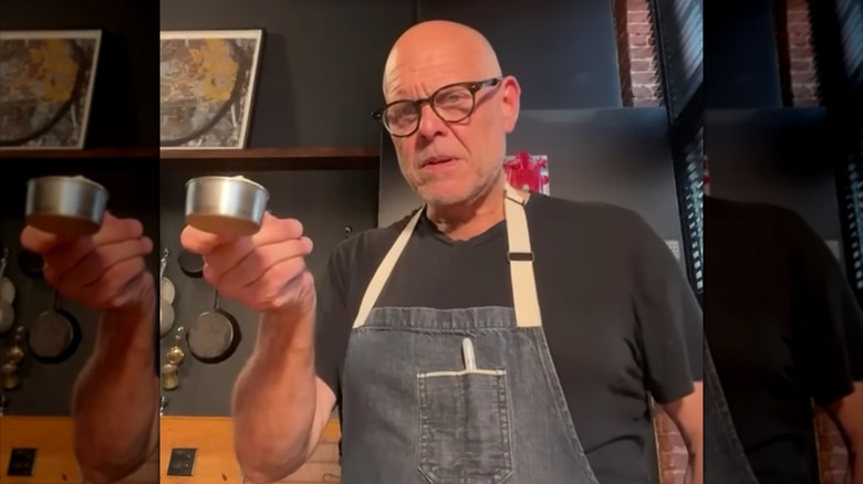 alton brown putting butter into a measuring cup