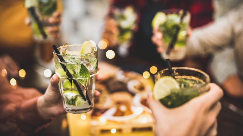 left-handed drinker toasting cocktails