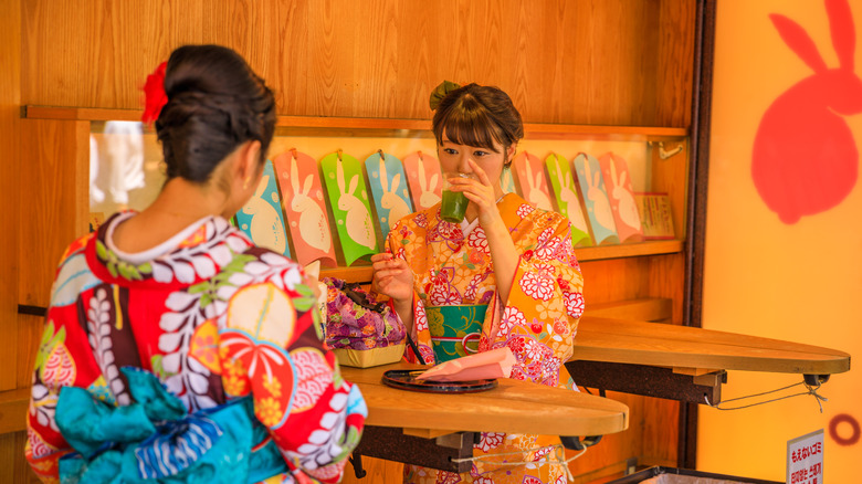 Two people drinking amazake at a cafe