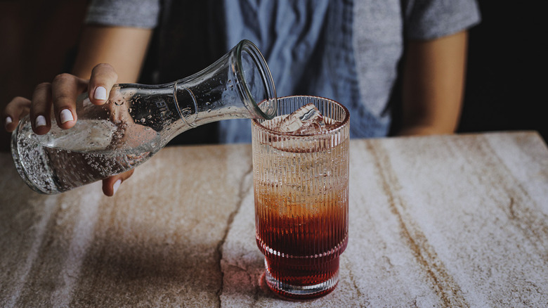 topping with soda water from carafe