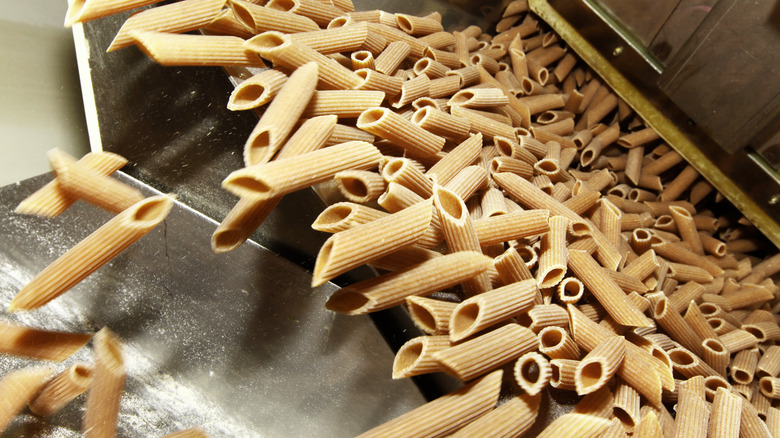 uncooked pasta falling from pasta machine