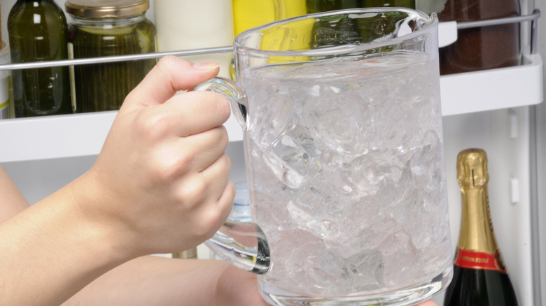 Putting water into fridge