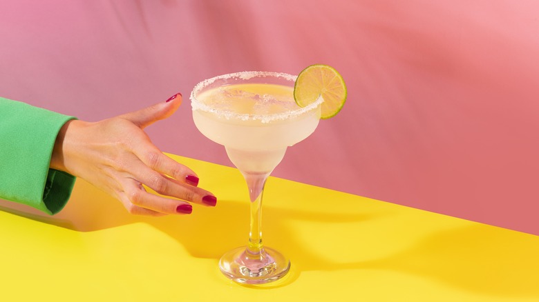 female hand grabbing cocktail