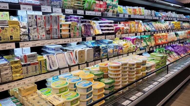 Various packages of butter in grocery store aisle