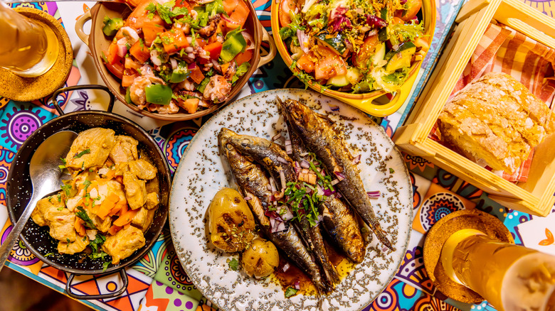 grilled sardines with side dishes and bread