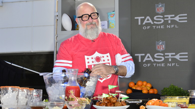 Andrew Zimmern wearing football jersey