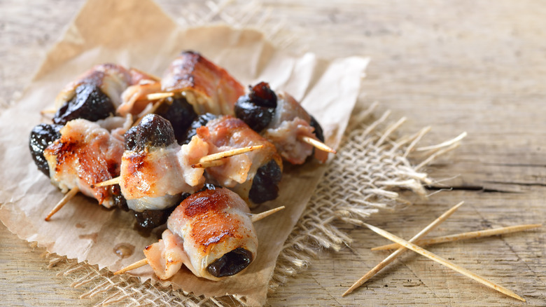 Fried prunes wrapped in bacon