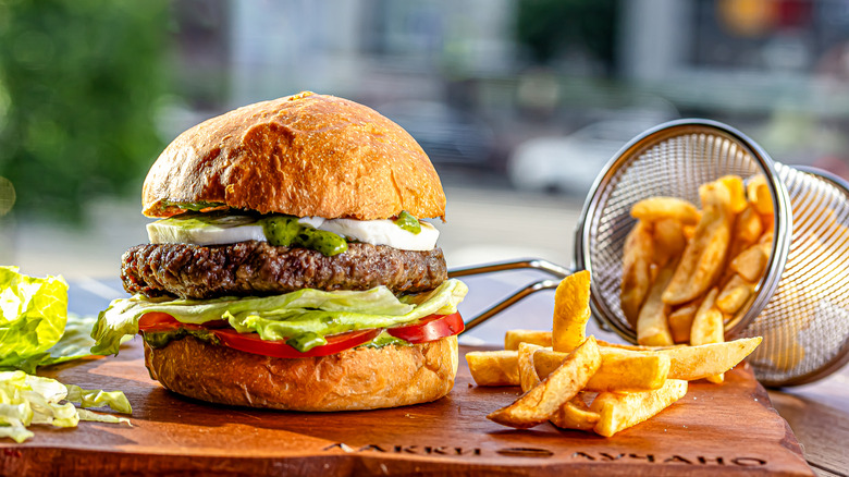 burger and fries on wood board