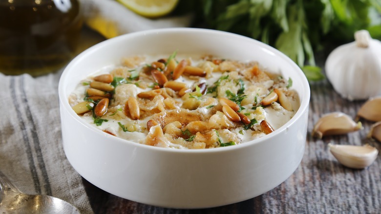 Bowl of hummus with pine nuts