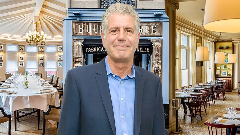 Anthony Bourdain standing in a French restaurant