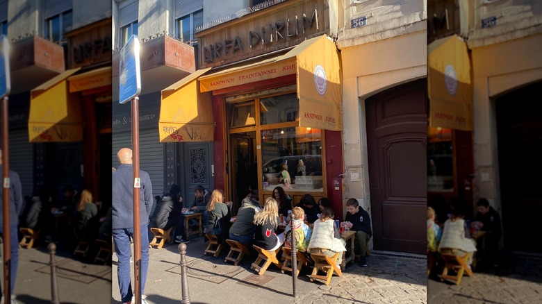 outside view of urfa durum in paris with people sitting outside