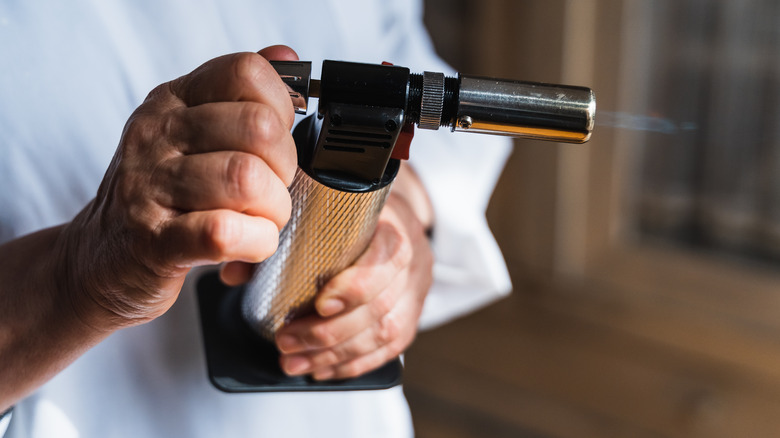 Chef holding a kitchen torch