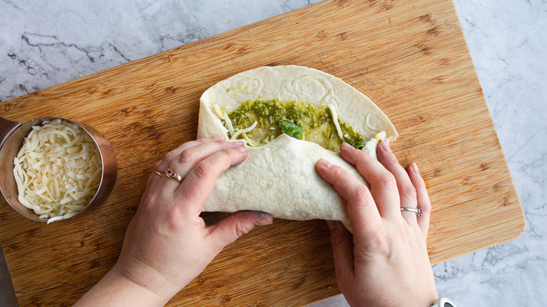 hand rolling up wrap