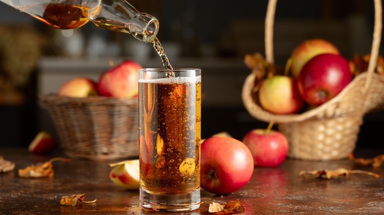 Apple cider being poured into glass