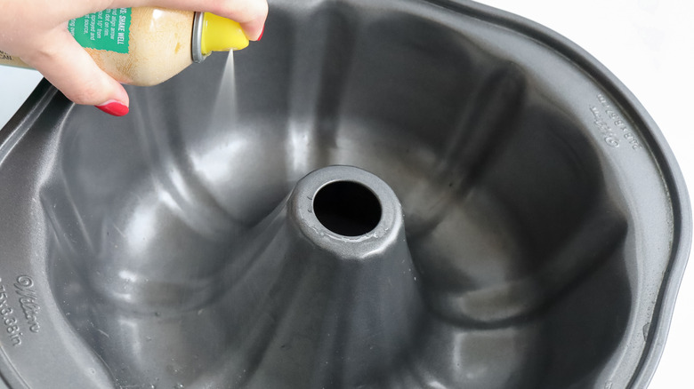 spraying oil in bundt pan