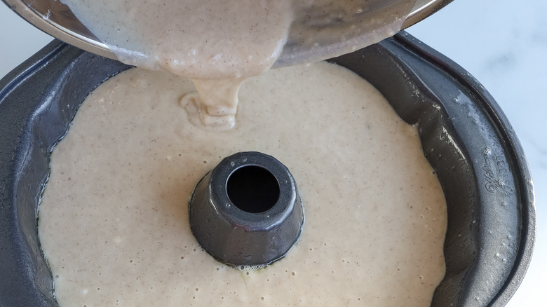 pouring cake batter into pan