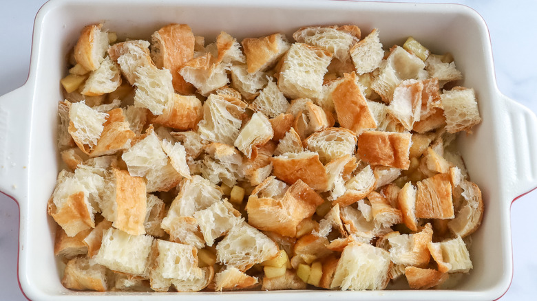 Cubed croissants in a casserole dish