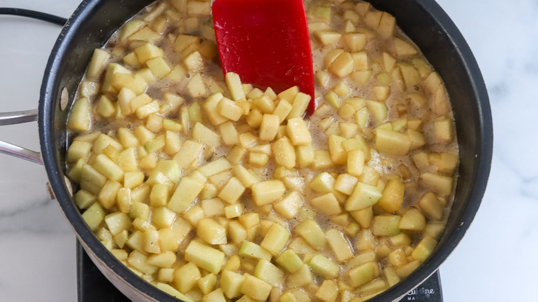 Cubed apples being cooked in a pan