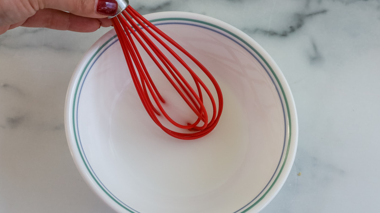 Cornstarch and water being whisked in a bowl