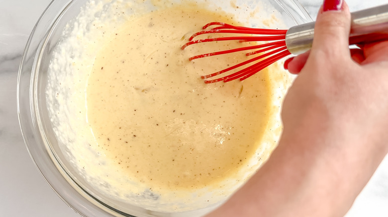 Casserole ingredients being whisked in a bowl