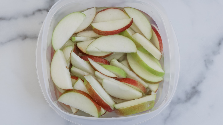 apples in container with liquid