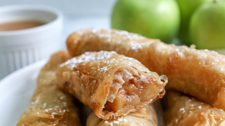 a cut open apple pie phyllo roll on a plate