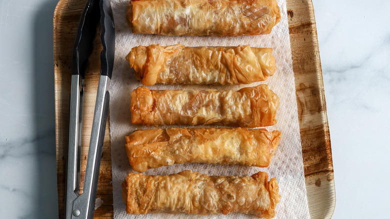 apple pie phyllo rolls on a paper towel lined plate