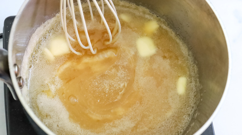 butter being whisked into caramel