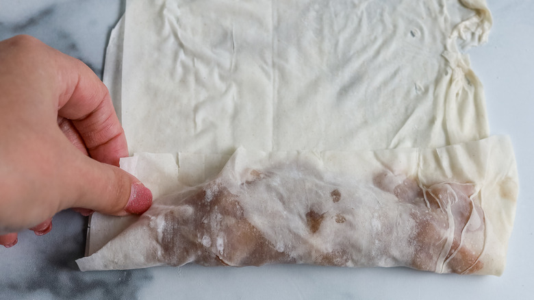 phyllo dough being folded over filling