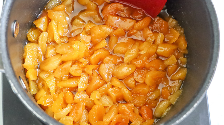 cooked apricots in metal pot