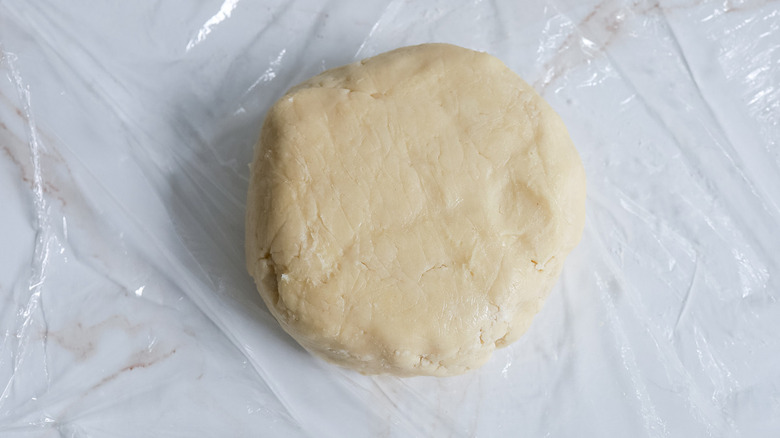 tart dough on plastic wrap