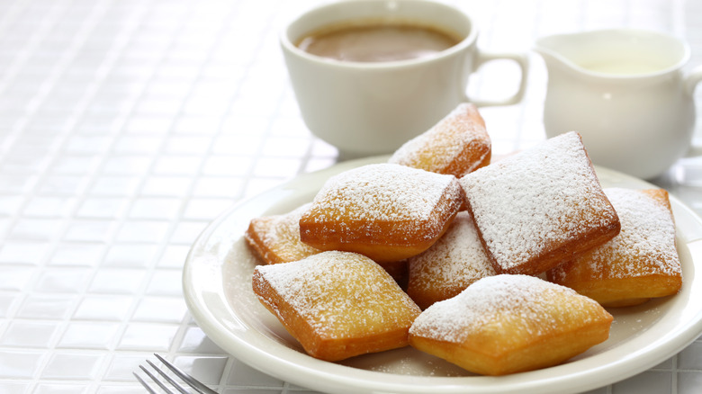 Beignets on plate with coffee