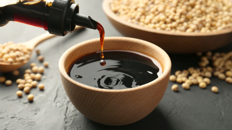 pouring soy sauce into a bowl