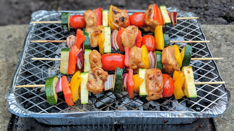 Veggie skewers on disposable grill