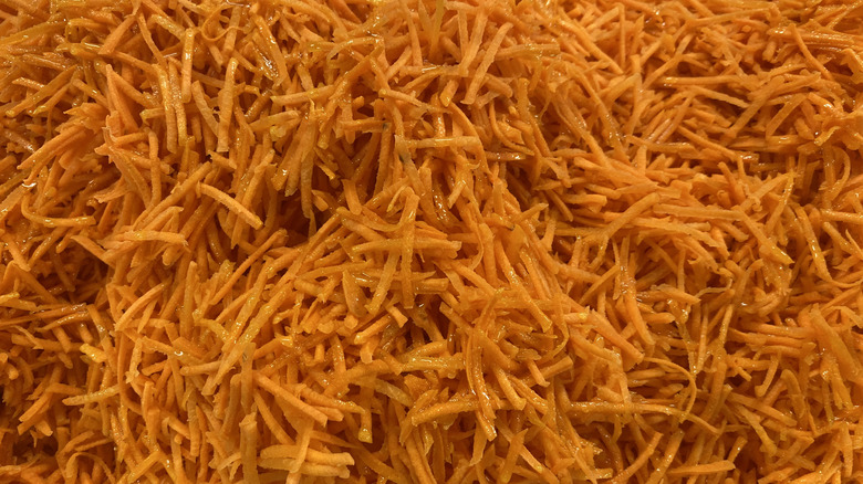 Fresh shredded carrots as background