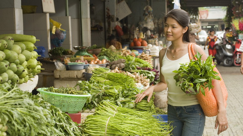 Women shopping for fresh produce at farmers market 