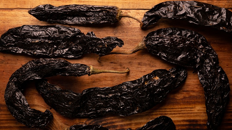 dried chiles pasilla on wooden table