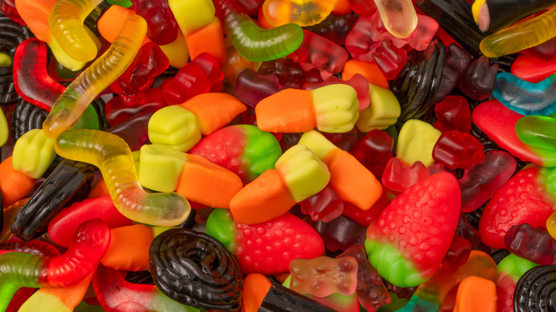 Assorted types of gummy candy are in a pile.