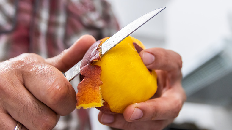 peeling peach with paring knife