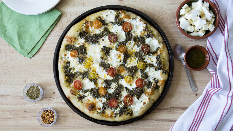 chimichurri pizza served on table