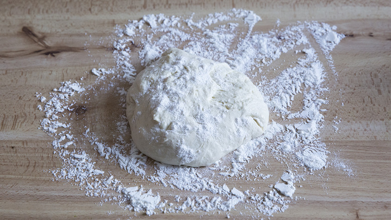 floured dough ball on table