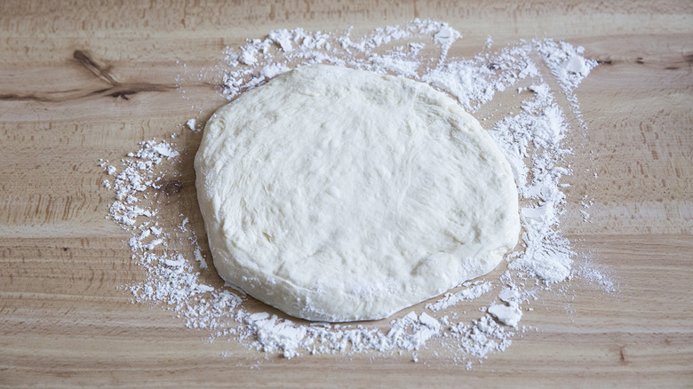 pizza dough disc on table